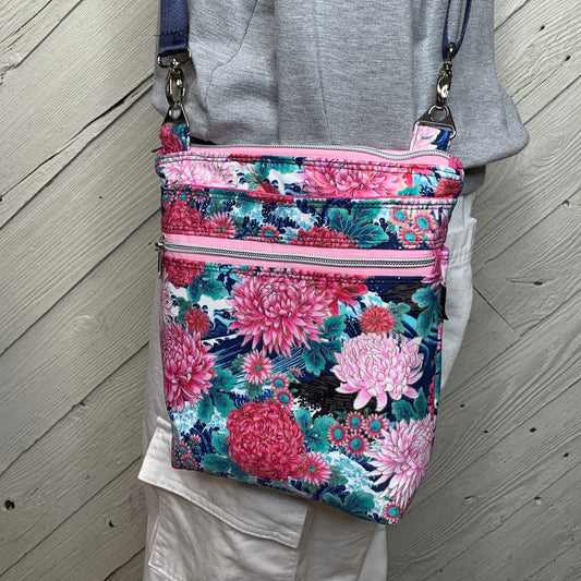Crossbody bag with navy background and pink flowers