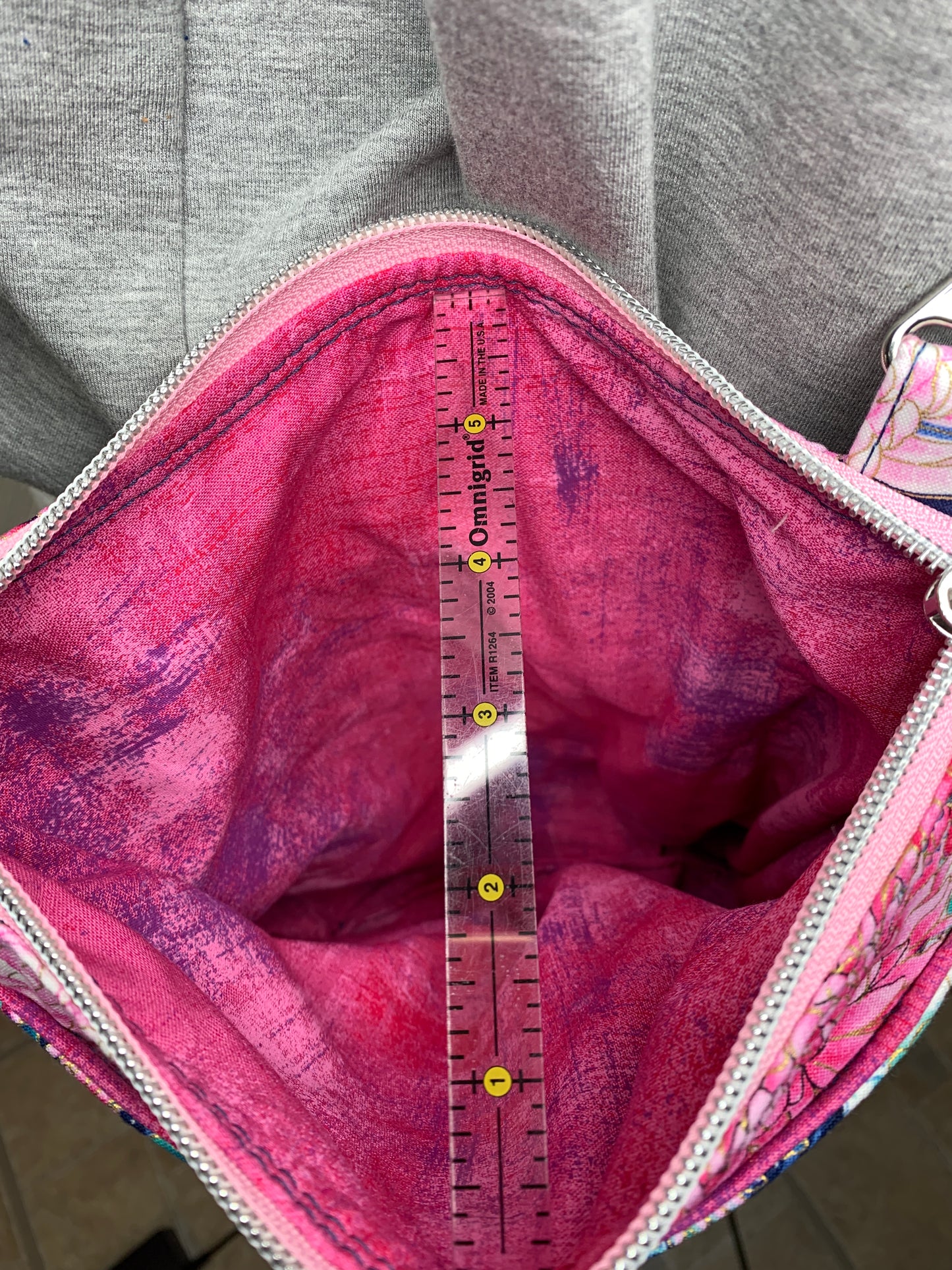 Crossbody bag with navy background and pink flowers